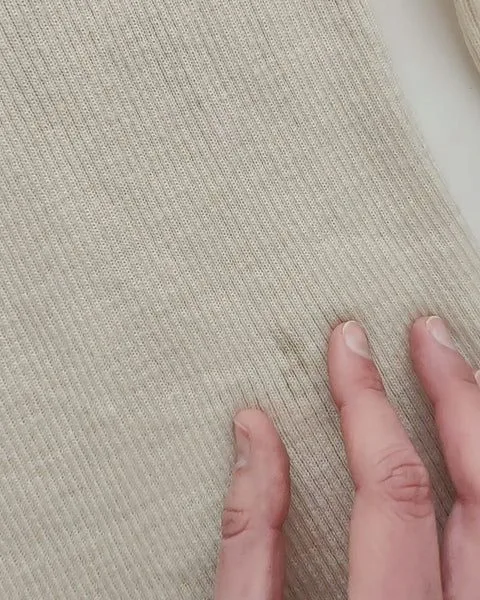 Cream wool turtleneck with stains before dyeing