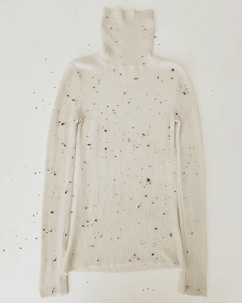 Rolling the turtleneck with petals inside