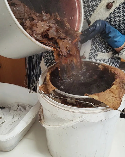 Straining oak leaves dye