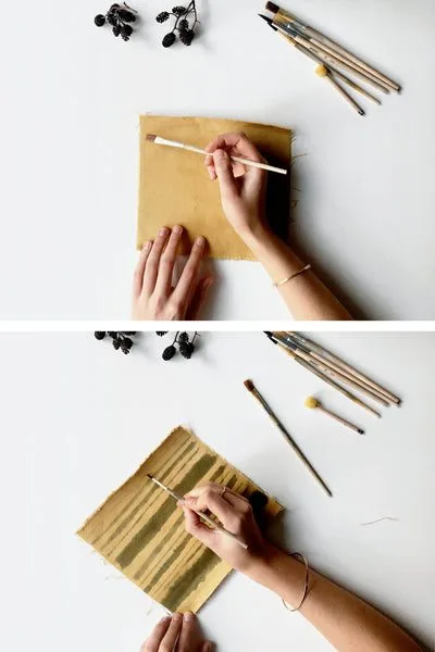 Painting plant-dyed fabric with a thin brush and iron water